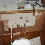 Removing the old structure behind thet toilet in the head