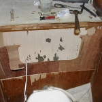 Removing the old structure behind thet toilet in the head