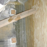 Holding the bulkhead in place as the tabbing cures